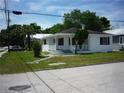 Classic home features a covered front porch with decorative white railings and a well-maintained lawn at 2414 E 8Th Ave, Tampa, FL 33605