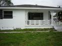 Quaint home with a covered front porch, detailed columns, and decorative railings at 2414 E 8Th Ave, Tampa, FL 33605