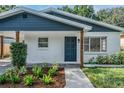 Close up of the front of the home, showing the entry door, fresh landscaping, and address at 3908 W Laurel St, Tampa, FL 33607