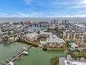 Scenic aerial view of the property's proximity to the water and surrounding neighborhood and cityscape at 399 150Th Ave # 101A, Madeira Beach, FL 33708