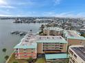 Aerial view showcases the property's waterfront location and building's architecture, outlined in red at 399 150Th Ave # 101A, Madeira Beach, FL 33708