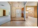 Home foyer with tiled floor, mirrored wall, archways, and white front door at 421 Wayfarer Ct, Tarpon Springs, FL 34689