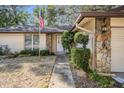 Close-up of the home's front entrance with stone facade and neat landscaping at 421 Wayfarer Ct, Tarpon Springs, FL 34689