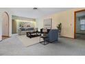 Bright living room featuring neutral tones, comfortable seating, and large windows at 421 Wayfarer Ct, Tarpon Springs, FL 34689