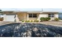 Inviting front exterior featuring a well-lit entrance, decorative stonework, and landscaped garden area at 4435 34Th N Ave, St Petersburg, FL 33713