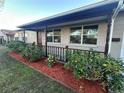 Inviting front porch featuring brick accents, a low railing, and neatly landscaped flower beds at 4790 81St N Ave, Pinellas Park, FL 33781