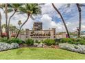 Entrance to Seamark Private Residence with lush landscaping, palm trees, and the building in the background at 5396 Gulf Blvd # 110, St Pete Beach, FL 33706