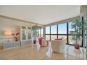 Bright living room with large windows showcasing a beachfront view, modern furniture and wood floors at 5396 Gulf Blvd # 904, St Pete Beach, FL 33706