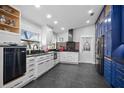 Modern kitchen with white cabinets, black countertops, and sleek appliances at 6531 Clair Shore Dr, Apollo Beach, FL 33572