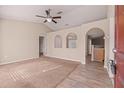 Spacious open-plan living room with a ceiling fan and views of adjoining dining and kitchen areas at 9117 Northcliffe Blvd, Spring Hill, FL 34606