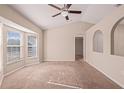 Bright living room featuring large windows, vaulted ceilings, neutral paint and carpeted floors at 9117 Northcliffe Blvd, Spring Hill, FL 34606