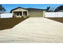 Lovely one-story home boasts a spacious driveway and a manicured lawn at 9377 Benrock Rd, Spring Hill, FL 34608