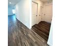 Inviting hallway featuring modern wood-style flooring, and ample closet space at 9377 Benrock Rd, Spring Hill, FL 34608