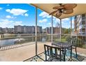 Relaxing screened patio with a ceiling fan offers a stunning view of the waterfront and fountain at 960 Starkey Rd # 3106, Largo, FL 33771