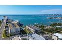 Stunning aerial view of a coastal community with waterfront condos, a bay, and a bridge in the distance at 100 Bluff View Dr # 514A, Belleair Bluffs, FL 33770