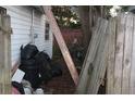 Exterior shot showcasing neglected side yard at 10554 116Th N Ave, Largo, FL 33773