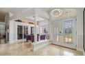 Bright foyer with high ceilings, decorative columns, tile floors and wine storage at 1123 Hounds Run, Safety Harbor, FL 34695