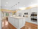 Spacious kitchen features white cabinets, granite countertops, stainless steel appliances, and hardwood floors at 11806 Willow Point Way, Tampa, FL 33618