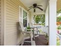 Relaxing front porch with ceiling fan and comfortable seating at 1312 Gulf Rd, Tarpon Springs, FL 34689