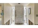 Front door entrance featuring a white door with sidelights and tiled flooring at 1431 54Th Ne Ave, St Petersburg, FL 33703