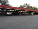 Covered parking area showcasing several parked cars, providing shelter and convenience at 2623 Seville Blvd # 111, Clearwater, FL 33764