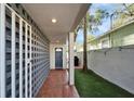 Covered entrance with brick pavers and white concrete block privacy wall at 3308 W Santiago St # B, Tampa, FL 33629