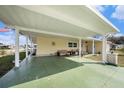 Spacious carport offering covered parking and a cozy seating area, perfect for enjoying the outdoors at 35020 Colony Hills Dr, Zephyrhills, FL 33541