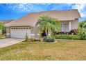 This is a beautiful, single story home that features a 2-car garage and mature landscaping at 6208 Forrestal Dr, Tampa, FL 33625