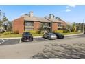 Condo building featuring a brick facade, screened balconies, and ample parking in a well-maintained community at 9100 Mlk N St # 201, St Petersburg, FL 33702