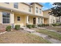 Charming townhome exterior featuring stone accents, lush greenery, and a welcoming entrance for relaxed living at 10944 Keys Gate Dr, Riverview, FL 33579