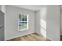 Bright room with wood floor and a window offering natural light and a pleasant outdoor view at 11073 Jackdaw Rd, Weeki Wachee, FL 34614