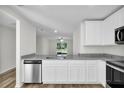 Open kitchen showcasing granite countertops, stainless steel appliances, and a view to the backyard at 11073 Jackdaw Rd, Weeki Wachee, FL 34614