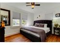 Inviting bedroom with plush bedding, natural light, and hardwood floors at 1208 E Giddens Ave, Tampa, FL 33603