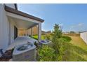 An expansive covered back patio is perfect for outdoor gatherings, overlooking a lush green lawn at 12779 Fisherville Way, Riverview, FL 33579