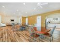 Community room featuring laminate floors, communal tables, and a partial kitchen at 13553 Newbridge St, Spring Hill, FL 34609
