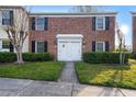 Charming brick townhome featuring a manicured lawn and double door entry at 13733 Juniper Blossom Dr, Tampa, FL 33618