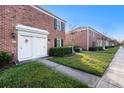 Brick townhome with a manicured lawn, offering curb appeal in a neighborhood setting at 13733 Juniper Blossom Dr, Tampa, FL 33618