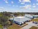 Wide aerial shot of the property displaying the roof, surrounding landscape, and neighborhood at 23227 Club Villas Dr # 38, Land O Lakes, FL 34639