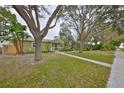 Quaint home with a well-maintained lawn, mature trees, and inviting front porch at 235 16Th Se Ave, St Petersburg, FL 33701