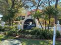 Audubon Condominiums at Feather Sound entrance sign with manicured landscaping and mature trees at 2400 Feather Sound Dr # 1016, Clearwater, FL 33762