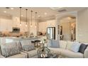 Open-concept kitchen and living area featuring modern appliances, ample counter space, and stylish furnishings at 26842 Dove Dr, Punta Gorda, FL 33955