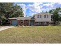 Charming two-story home featuring a brick facade, blue door, and well-maintained lawn at 407 Cranberry Ln, Brandon, FL 33510