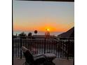 Balcony scene with comfortable chair facing a captivating ocean sunset view at 7600 Bayshore Dr # 204, Treasure Island, FL 33706