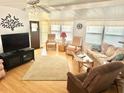 Bright living room with wood floors, ample seating, and plenty of natural light at 9790 66Th N St # 206, Pinellas Park, FL 33782