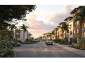 Street view of Aqua Reserve modern townhomes featuring tropical landscaping, architecture, and a welcoming neighborhood atmosphere at 1 Aqua Reserve Blvd, New Port Richey, FL 34652