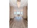 Elegant living room showcasing an ornate chandelier and inviting furniture arrangement at 10 Papaya St # 1404, Clearwater Beach, FL 33767