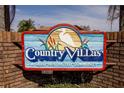 A welcoming brick and wooden sign indicating a deed-restricted community named Country Villas at 112 Forest Cir, Safety Harbor, FL 34695