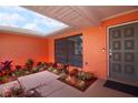 Covered front entrance courtyard with tiled floor and colorful plants at 112 Forest Cir, Safety Harbor, FL 34695