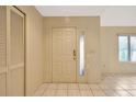 Bright front entryway showcasing a coat closet, tile flooring, and entry door with side light at 13128 Hazelcrest St, Spring Hill, FL 34609