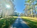 Long driveway lined with mature trees that leads up to the house at 18840 Rustic Woods Trl, Odessa, FL 33556